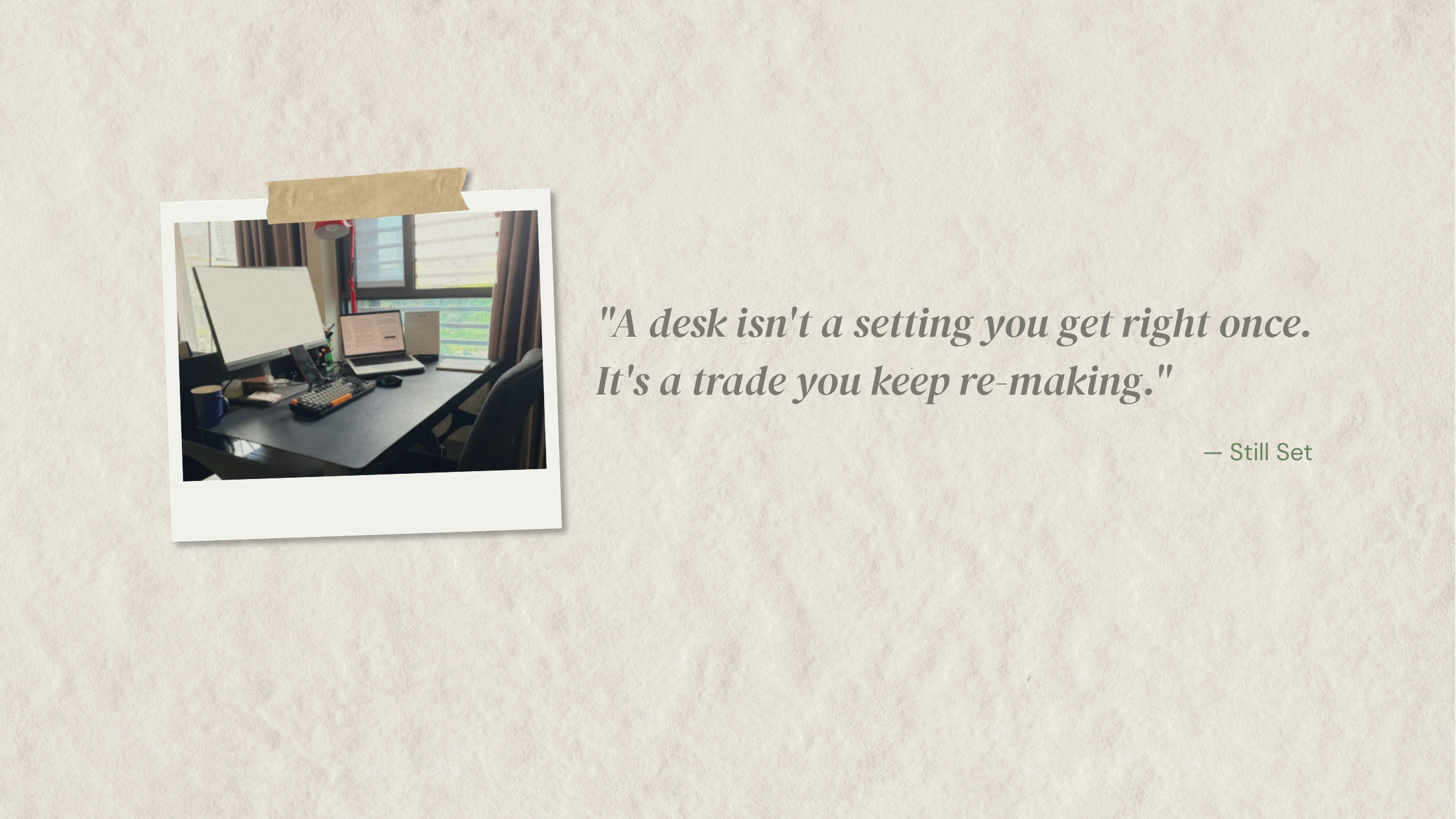 A softly blurred photo of a real work desk beside a window, with a lamp and coffee mug